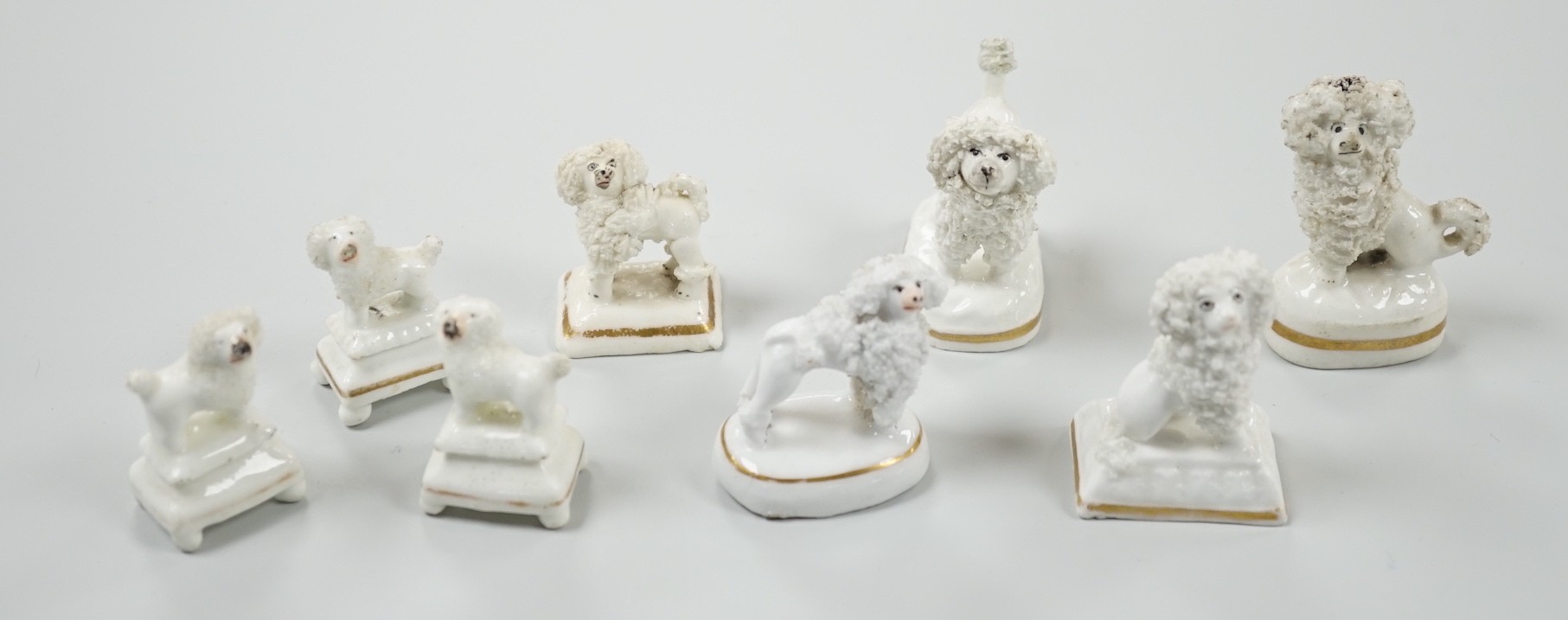 Four small Staffordshire porcelain models of poodles, together with five toy Staffordshire models of poodles, c.1830-50. Largest 5cm tall, Provenance- Dennis G Rice collection
